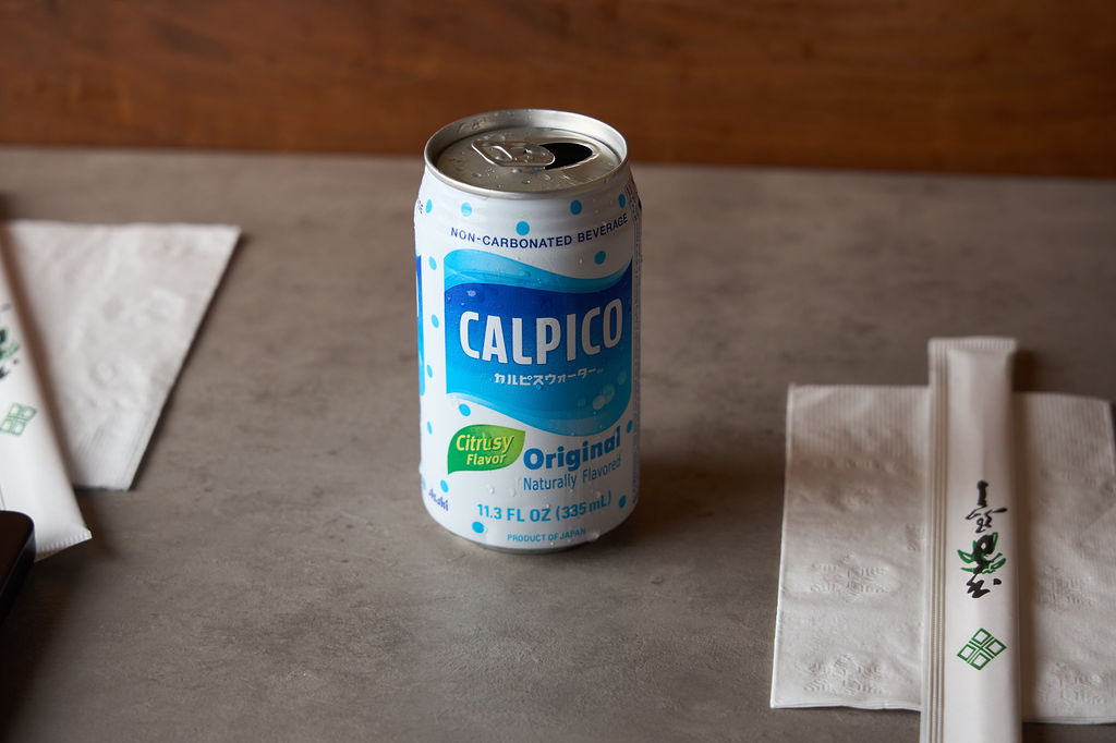 Calpico Japanese non-carbonated beverage can with Umaimon chopstick wrappers